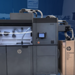 HP Multi Jet Fusion 4200 3D Printer on a faded blue background at Impac Additive 3D