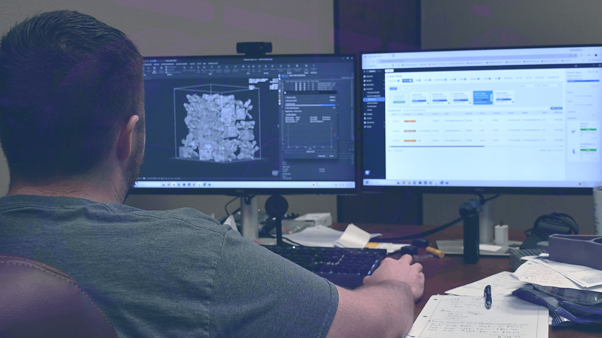 Over-the-shoulder photo of engineer working on computer, CAD design visible on screen