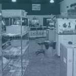 IA3D's print room, worker visible cleaning powder off parts